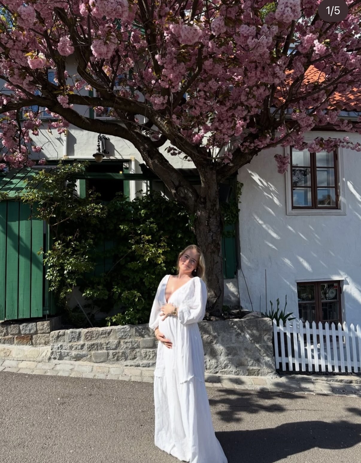 CHEZ LOLA pearl earrings worn beneath a flowering cherry tree