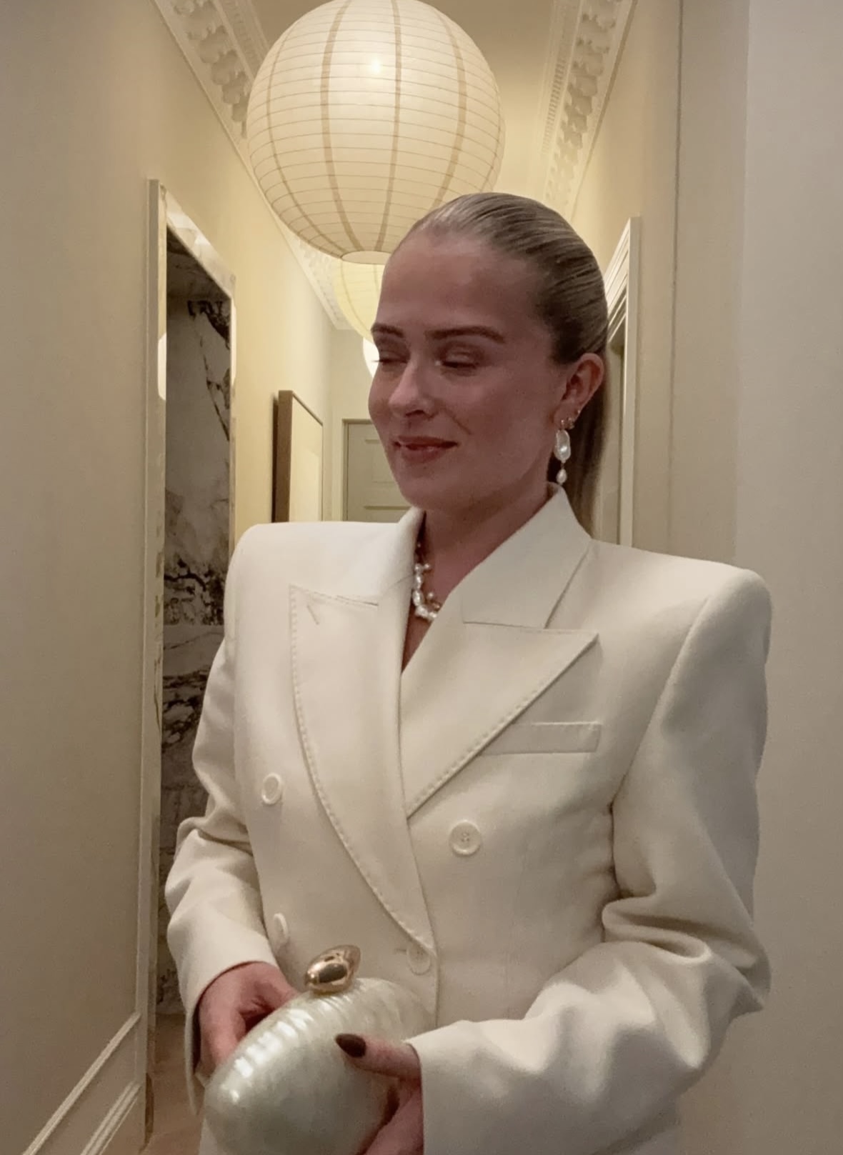 Statement pearl jewellery styled with a white suit